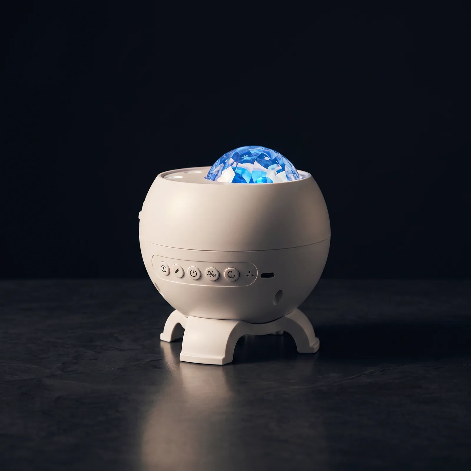 The aurora projector alone in the dark — its violet-blue dome the only light in the room